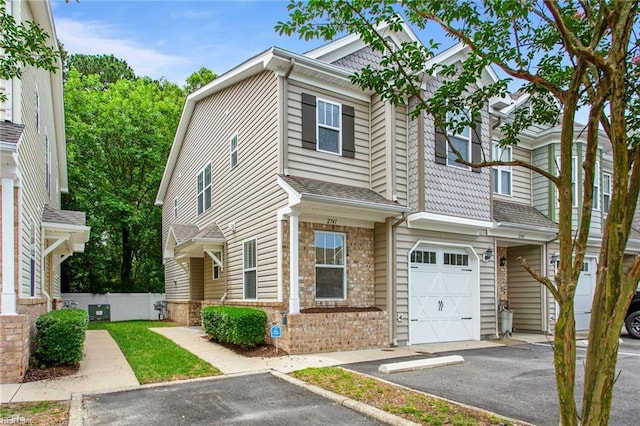 2741 Deep Creek Cmn, Chesapeake, VA 23323 - townhome / multi-family property featuring an attached garage, asphalt driveway, and brick siding
