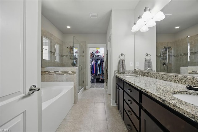 220 Wisdom Path, Chesapeake, VA 23322 - bathroom featuring a stall shower, double vanity, a garden tub, tile patterned flooring, and a spacious closet