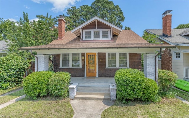418 Massachusetts Ave, Norfolk, VA 23508 - bungalow-style house featuring a porch, a chimney, roof with shingles, and a front lawn
