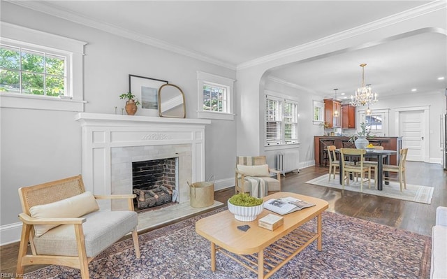 418 Massachusetts Ave, Norfolk, VA 23508 - living room with healthy amount of natural light, dark wood finished floors, a tile fireplace, crown molding, and a chandelier