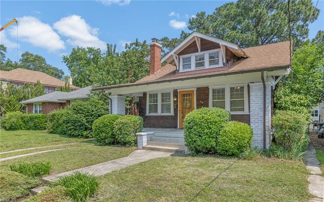 418 Massachusetts Ave, Norfolk, VA 23508 - bungalow with a chimney, a porch, a front yard, and brick siding