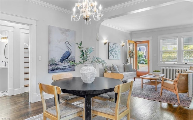 418 Massachusetts Ave, Norfolk, VA 23508 - dining area with radiator, wood finished floors, ornamental molding, a chandelier, and arched walkways