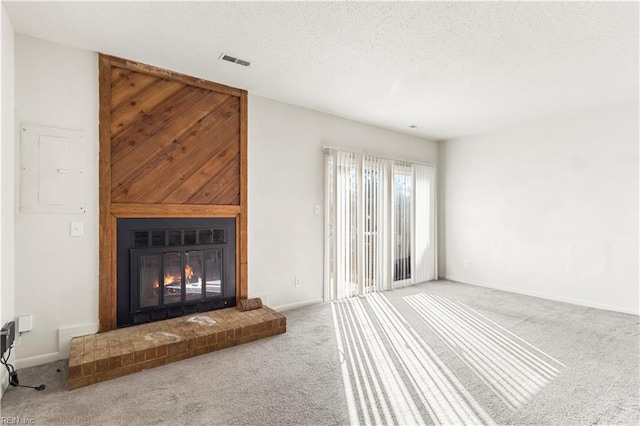 900 Monarch Dr, Virginia Beach, VA 23462 - unfurnished living room with carpet floors, electric panel, a large fireplace, and a textured ceiling