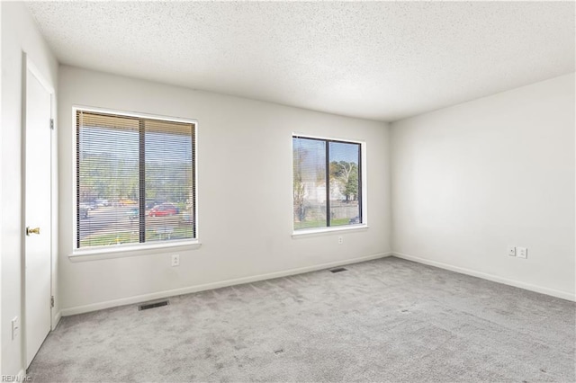 900 Monarch Dr, Virginia Beach, VA 23462 - unfurnished room featuring carpet floors, plenty of natural light, and a textured ceiling