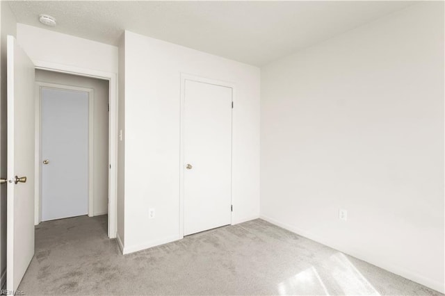 900 Monarch Dr, Virginia Beach, VA 23462 - unfurnished bedroom with light carpet and baseboards