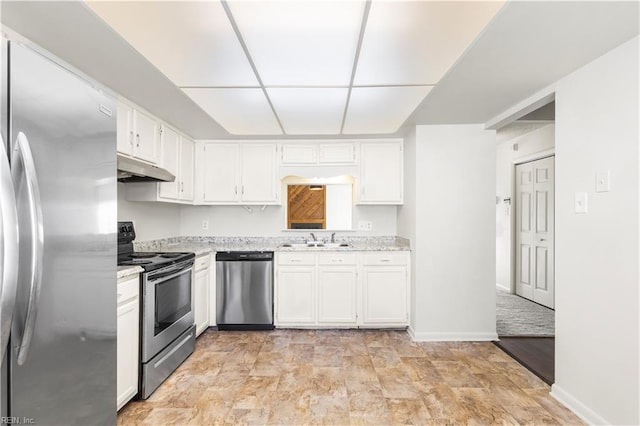 900 Monarch Dr, Virginia Beach, VA 23462 - kitchen with appliances with stainless steel finishes, under cabinet range hood, white cabinets, and light stone countertops