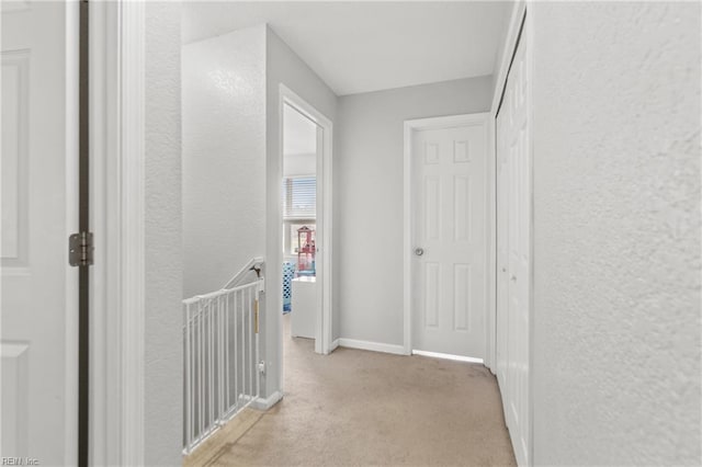 141 Long Pine Rd, South Mills, NC 27976 - hall featuring light colored carpet, a textured wall, and an upstairs landing