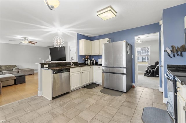 141 Long Pine Rd, South Mills, NC 27976 - kitchen featuring appliances with stainless steel finishes, dark countertops, open floor plan, ceiling fan, and a peninsula
