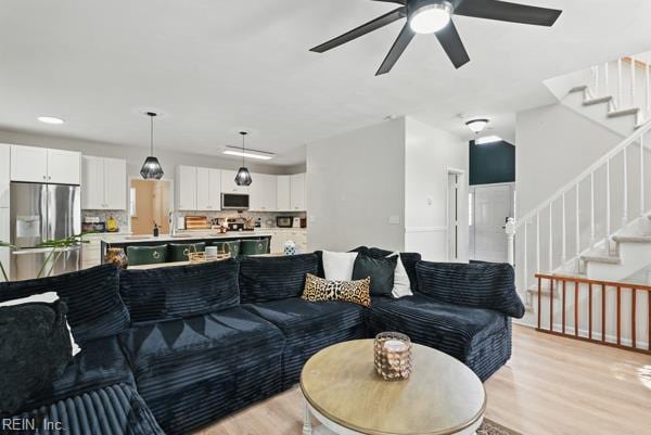 305 Ginkgo Ct, Suffolk, VA 23435 - living room featuring light wood-style floors, stairway, and ceiling fan