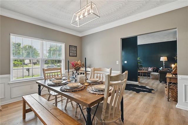 305 Ginkgo Ct, Suffolk, VA 23435 - dining room featuring light wood finished floors, crown molding, and wainscoting