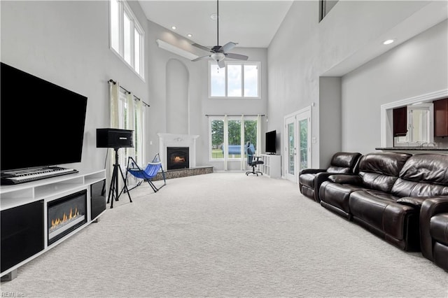 1207 Masers Row, Chesapeake, VA 23320 - living room with a glass covered fireplace, a towering ceiling, carpet, and ceiling fan