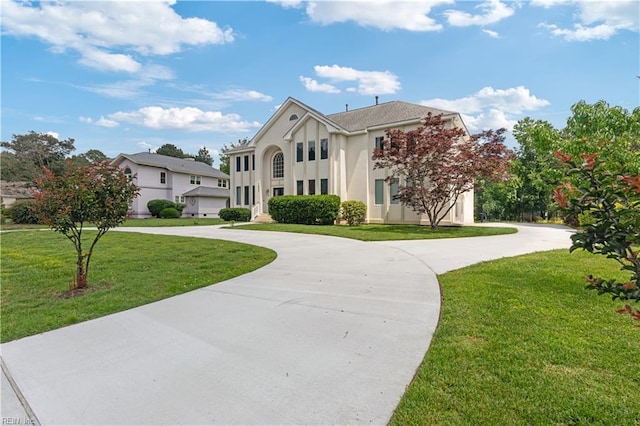 1207 Masers Row, Chesapeake, VA 23320 - neoclassical home featuring curved driveway, a front lawn, and stucco siding