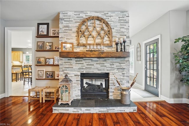 2316 Holland Rd, Virginia Beach, VA 23453 - living room featuring wood finished floors and a stone fireplace