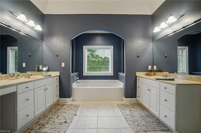2316 Holland Rd, Virginia Beach, VA 23453 - bathroom with two vanities, a garden tub, tile patterned flooring, and a textured wall