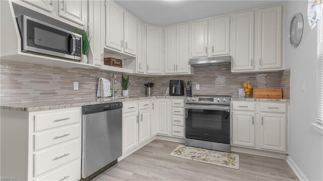 969 Sunnyside Dr, Virginia Beach, VA 23464 - kitchen with appliances with stainless steel finishes, under cabinet range hood, white cabinetry, and light wood-style flooring