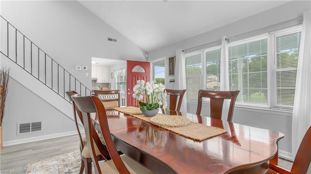 969 Sunnyside Dr, Virginia Beach, VA 23464 - dining space featuring light wood-style floors, stairway, and high vaulted ceiling