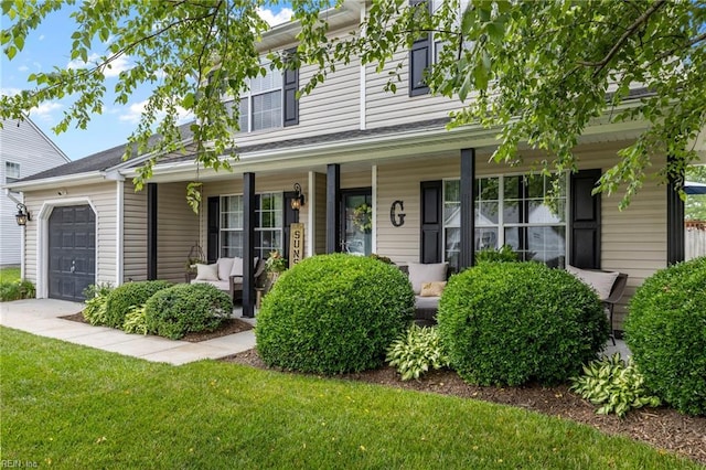 1205 Woods Way, Chesapeake, VA 23323 - view of front facade with a porch, a garage, and a front lawn
