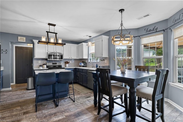 1205 Woods Way, Chesapeake, VA 23323 - kitchen featuring appliances with stainless steel finishes, a chandelier, a kitchen island, and decorative backsplash