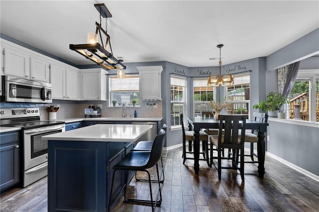 1205 Woods Way, Chesapeake, VA 23323 - kitchen featuring stainless steel appliances, a chandelier, light countertops, dark wood-style flooring, and tasteful backsplash
