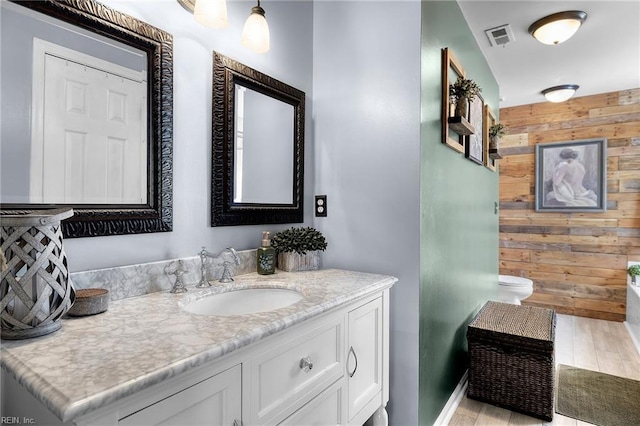 1205 Woods Way, Chesapeake, VA 23323 - bathroom featuring wooden walls, vanity, and wood finished floors