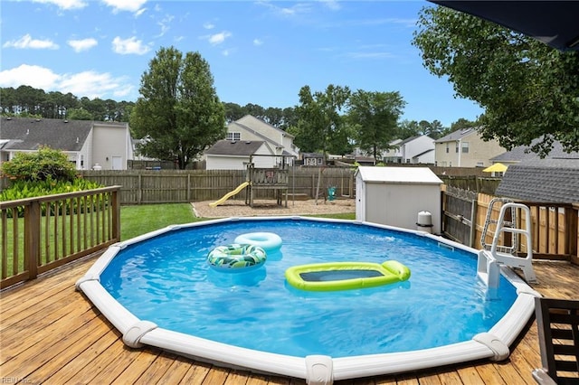 1205 Woods Way, Chesapeake, VA 23323 - view of swimming pool featuring a fenced backyard, a playground, a wooden deck, and a residential view