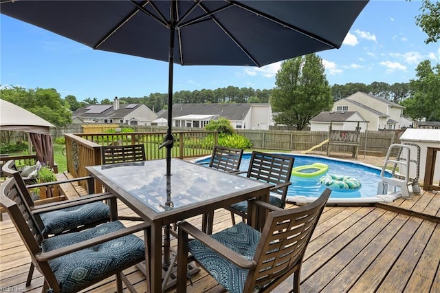 1205 Woods Way, Chesapeake, VA 23323 - wooden terrace with outdoor dining space, a fenced backyard, a residential view, and a playground