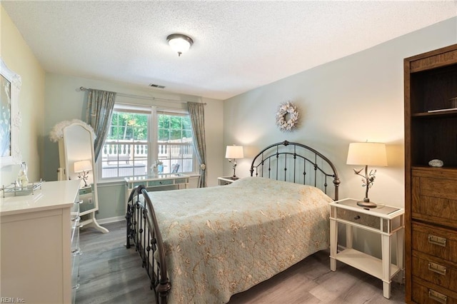 1013 Winged Foot Ct Unit A, Chesapeake, VA 23320 - bedroom featuring wood finished floors and a textured ceiling