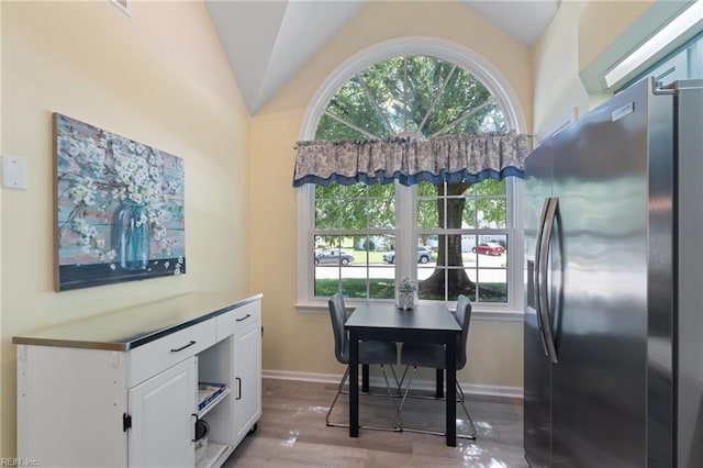 1013 Winged Foot Ct Unit A, Chesapeake, VA 23320 - kitchen featuring stainless steel fridge, white cabinetry, wood finished floors, plenty of natural light, and vaulted ceiling