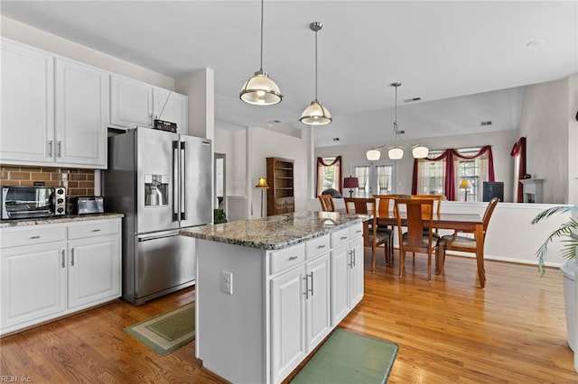 2000 Kelsey Bay Ct, Chesapeake, VA 23323 - kitchen featuring stainless steel fridge, white cabinets, light wood-style flooring, and a kitchen island