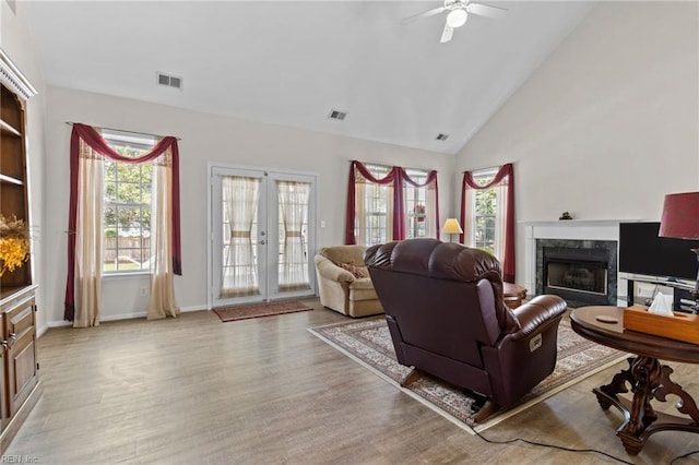 2000 Kelsey Bay Ct, Chesapeake, VA 23323 - living room with a premium fireplace, french doors, light wood-style floors, healthy amount of natural light, and high vaulted ceiling