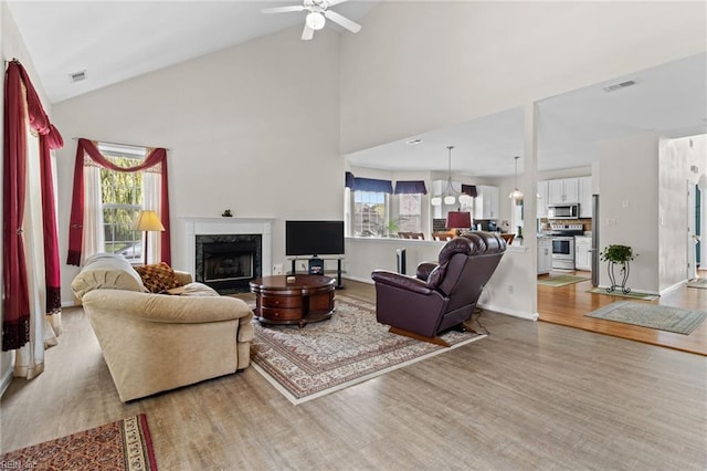 2000 Kelsey Bay Ct, Chesapeake, VA 23323 - living area featuring light wood-style floors, a high end fireplace, ceiling fan, and high vaulted ceiling