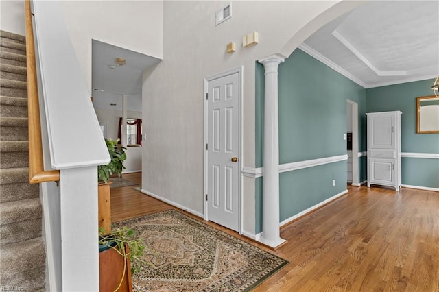 2000 Kelsey Bay Ct, Chesapeake, VA 23323 - foyer featuring wood finished floors, stairway, arched walkways, ornate columns, and crown molding