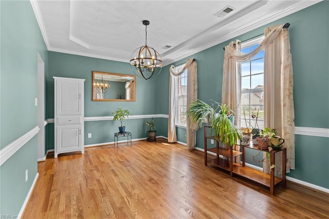 2000 Kelsey Bay Ct, Chesapeake, VA 23323 - spare room featuring a chandelier, wood finished floors, ornamental molding, and a raised ceiling