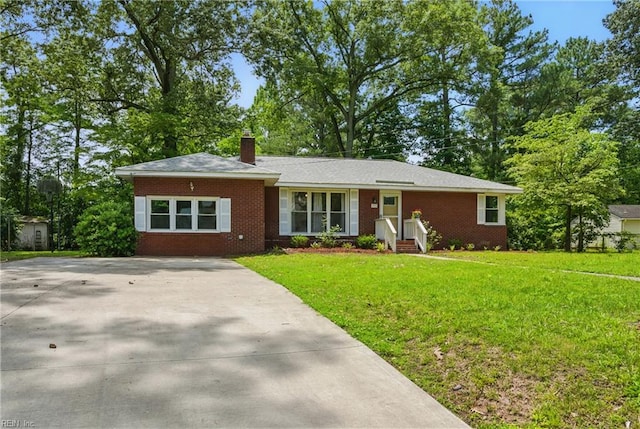 512 Rock Dr, Chesapeake, VA 23323 - ranch-style home with brick siding, a chimney, a front lawn, and driveway