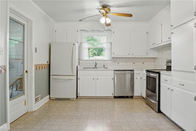 512 Rock Dr, Chesapeake, VA 23323 - kitchen featuring stainless steel appliances, light countertops, ceiling fan, white cabinets, and decorative backsplash