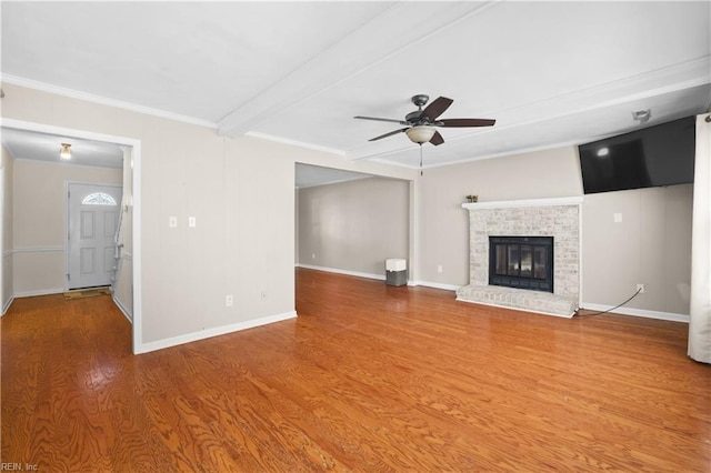 2505 Castle Hill Ct, Virginia Beach, VA 23454 - unfurnished living room with wood finished floors, ceiling fan, ornamental molding, beamed ceiling, and a brick fireplace