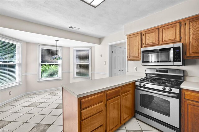 2505 Castle Hill Ct, Virginia Beach, VA 23454 - kitchen with stainless steel appliances, a peninsula, light tile patterned floors, light countertops, and brown cabinetry