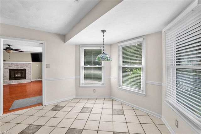 2505 Castle Hill Ct, Virginia Beach, VA 23454 - unfurnished dining area with a ceiling fan, light tile patterned flooring, and a glass covered fireplace