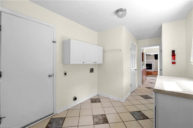 2505 Castle Hill Ct, Virginia Beach, VA 23454 - laundry area featuring hookup for an electric dryer, cabinet space, hookup for a washing machine, light tile patterned floors, and a fireplace