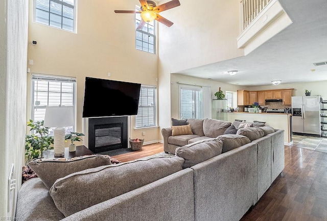 5537 Port Royal Dr, Virginia Beach, VA 23462 - living area with wood finished floors, plenty of natural light, ceiling fan, a towering ceiling, and a fireplace with flush hearth