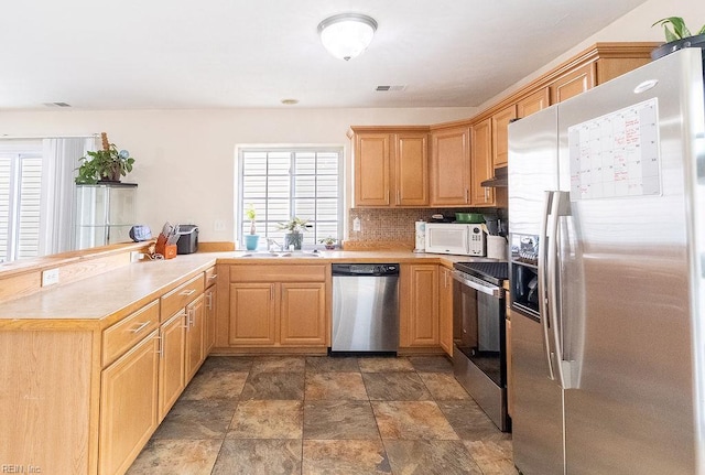 5537 Port Royal Dr, Virginia Beach, VA 23462 - kitchen with stainless steel appliances, light countertops, stone finish floors, and decorative backsplash