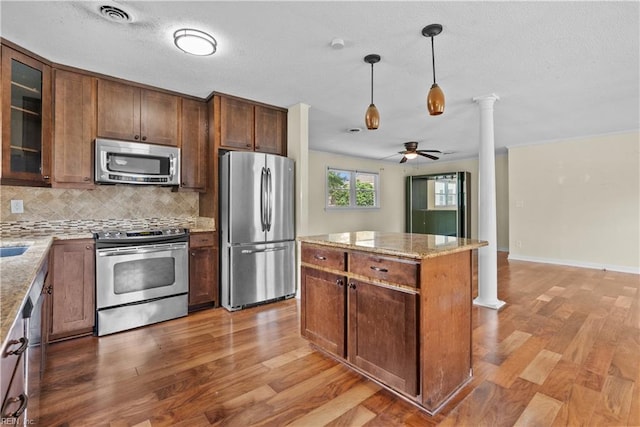 731 Carolina Ave, Virginia Beach, VA 23451 - kitchen with appliances with stainless steel finishes, decorative columns, a ceiling fan, light wood-style flooring, and backsplash