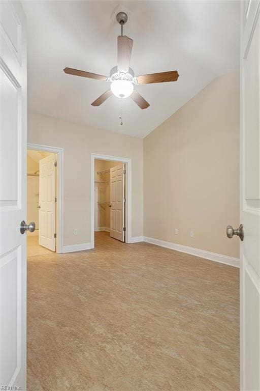 6885 Colemans Crossing Ave, Hayes, VA 23072 - unfurnished bedroom featuring a walk in closet, lofted ceiling, a closet, and ceiling fan