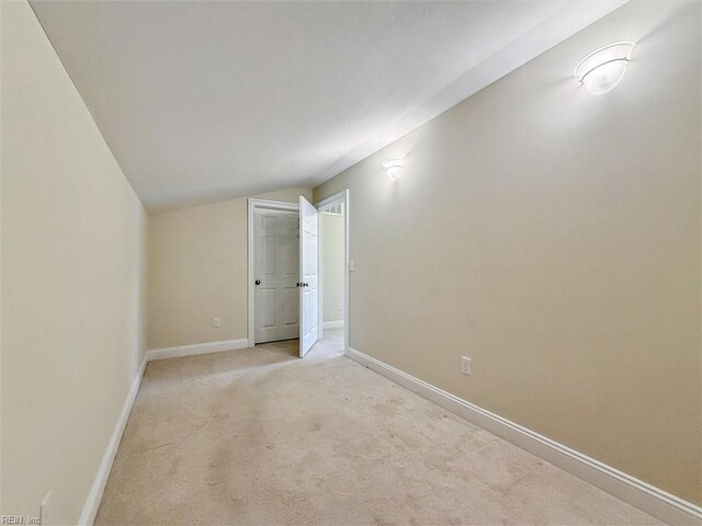 6885 Colemans Crossing Ave, Hayes, VA 23072 - empty room featuring vaulted ceiling and light carpet