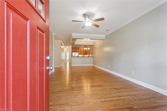 6885 Colemans Crossing Ave, Hayes, VA 23072 - unfurnished living room featuring light wood finished floors, ceiling fan, crown molding, and a chandelier