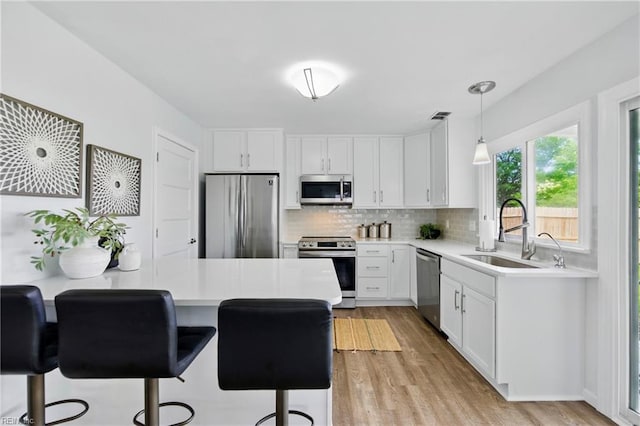 3441 Daisy Cres, Virginia Beach, VA 23453 - kitchen featuring appliances with stainless steel finishes, light countertops, backsplash, and light wood-type flooring