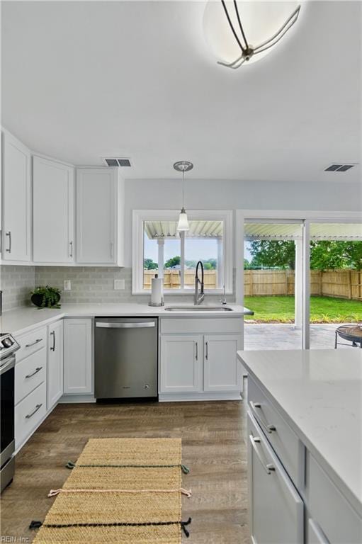 3441 Daisy Cres, Virginia Beach, VA 23453 - kitchen featuring appliances with stainless steel finishes, white cabinets, dark wood finished floors, and plenty of natural light