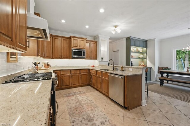 409 Torre Pine Ct, Chesapeake, VA 23322 - kitchen featuring appliances with stainless steel finishes, extractor fan, crown molding, brown cabinets, and light tile patterned flooring