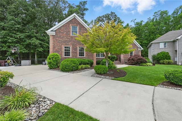 409 Torre Pine Ct, Chesapeake, VA 23322 - traditional-style house featuring brick siding and a front yard