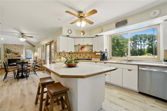1737 Pleasant Ridge Rd, Virginia Beach, VA 23457 - kitchen featuring stainless steel dishwasher, ceiling fan, backsplash, light wood finished floors, and lofted ceiling